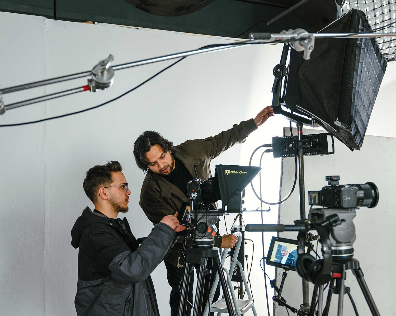 Film crew adjusting camera equipment outdoors
